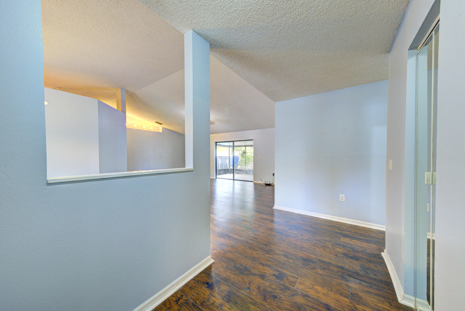 2423 Jaywood Road Titusville, FL 32780 - Photo 6 of 37 a view of an empty room with window and wooden floor