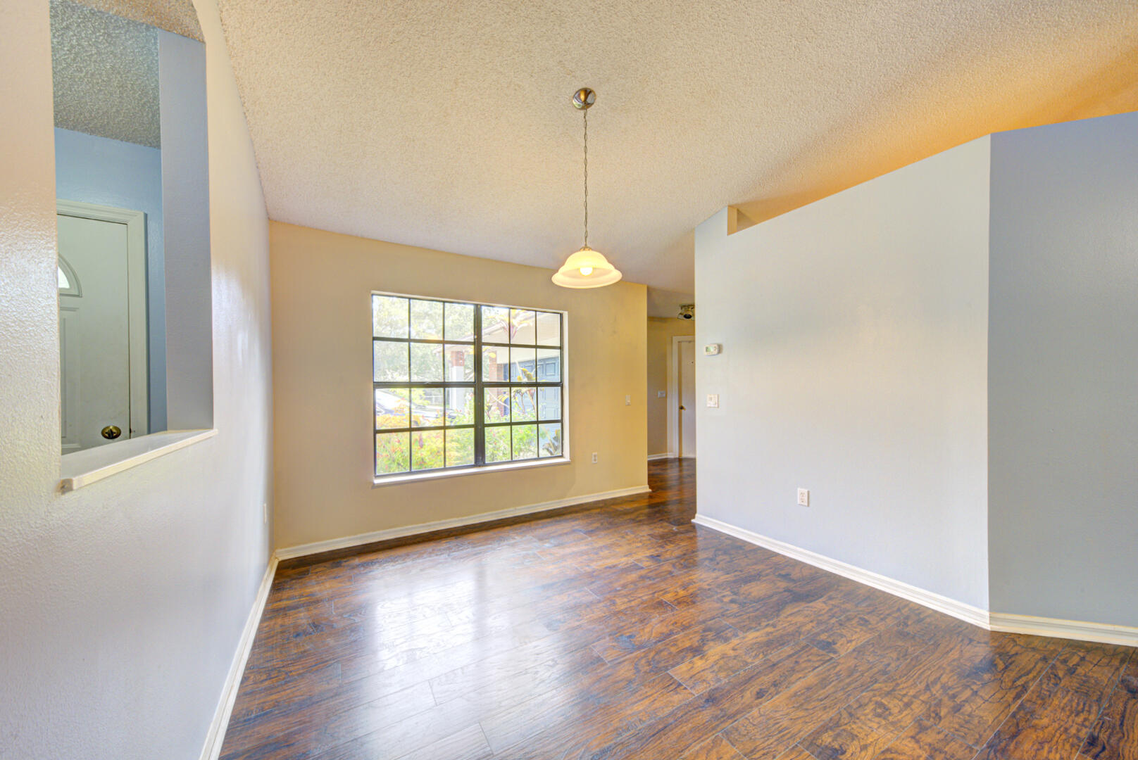 2423 Jaywood Road Titusville, FL 32780 - Photo 7 of 37 a view of an empty room with wooden floor and a window