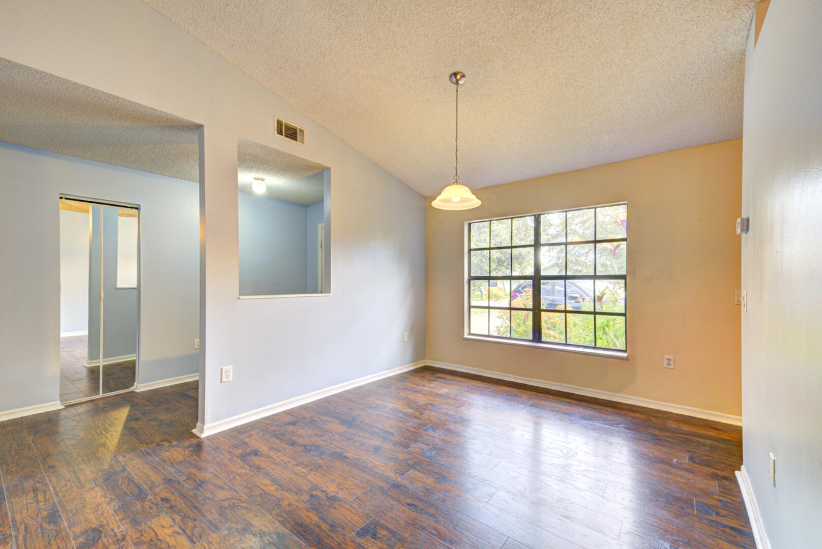 2423 Jaywood Road Titusville, FL 32780 - Photo 8 of 37 a view of an empty room with window and wooden floor