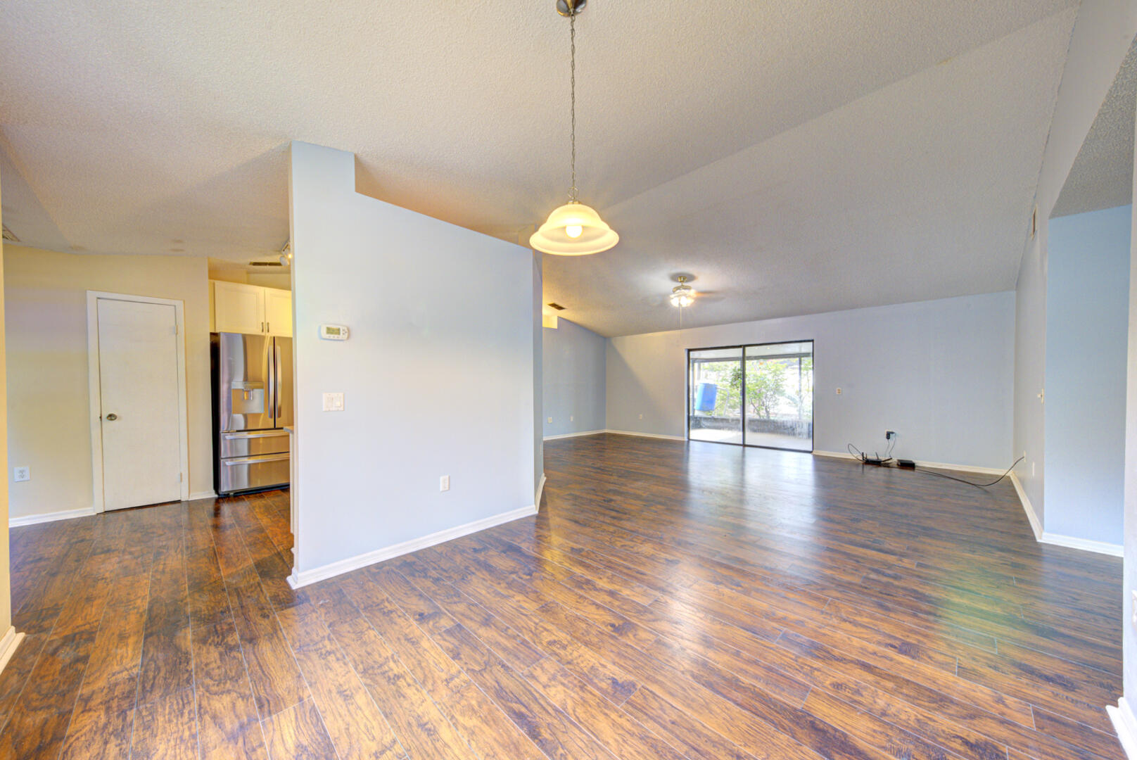 2423 Jaywood Road Titusville, FL 32780 - Photo 9 of 37 a view of an empty room with window and wooden floor