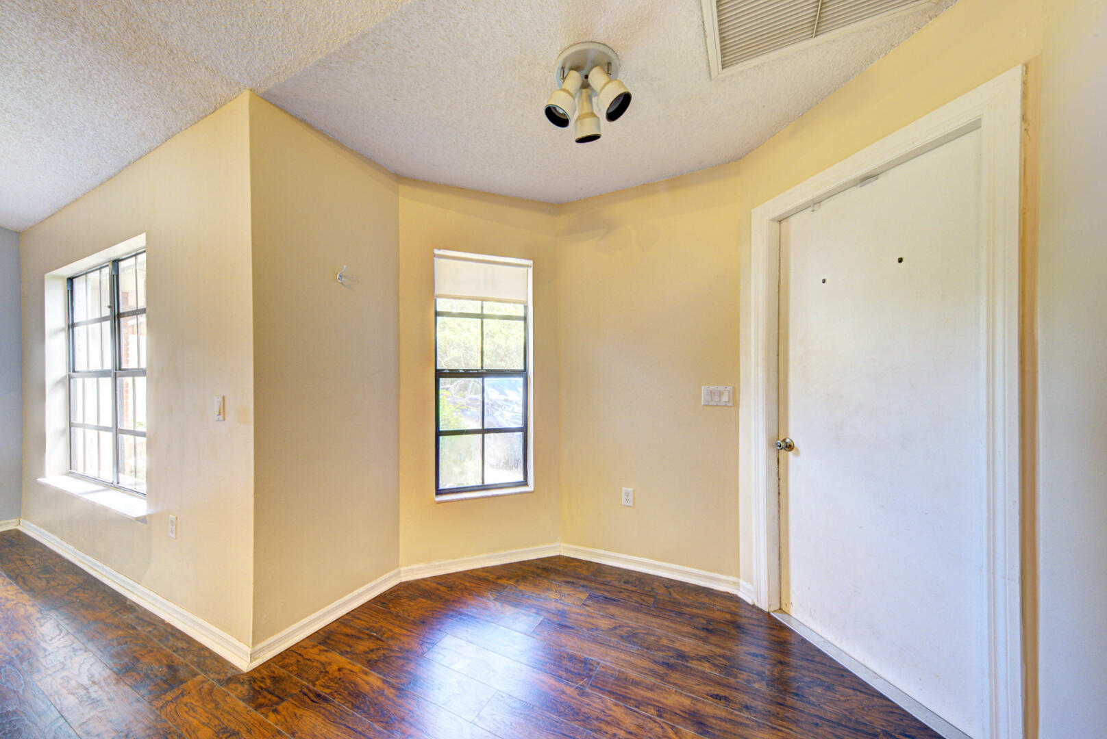 2423 Jaywood Road Titusville, FL 32780 - Photo 10 of 37 an empty room with wooden floor and windows