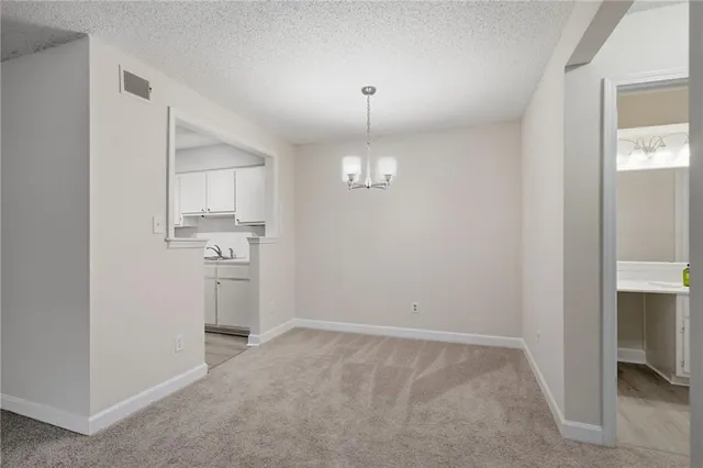 a kitchen with a sink a refrigerator and cabinets