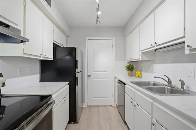 a kitchen with a sink and cabinets