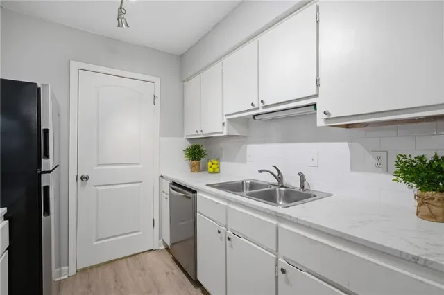 a kitchen with stainless steel appliances a refrigerator and cabinets