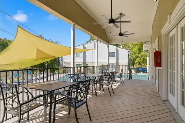 a view of a swimming pool with lawn chairs under an umbrella