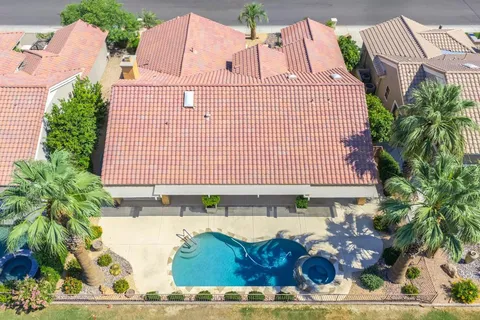an aerial view of a house with a yard