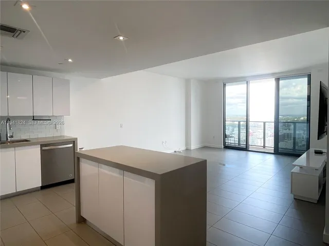 a kitchen with a sink and a stove top oven