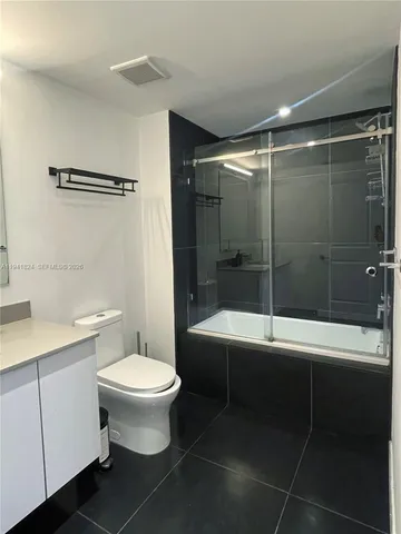 a bathroom with a toilet and a bathtub