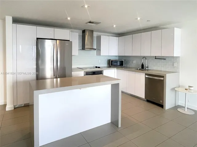 a kitchen with cabinets and stainless steel appliances