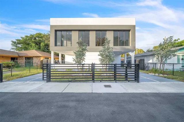 a view of a house with a yard and balcony