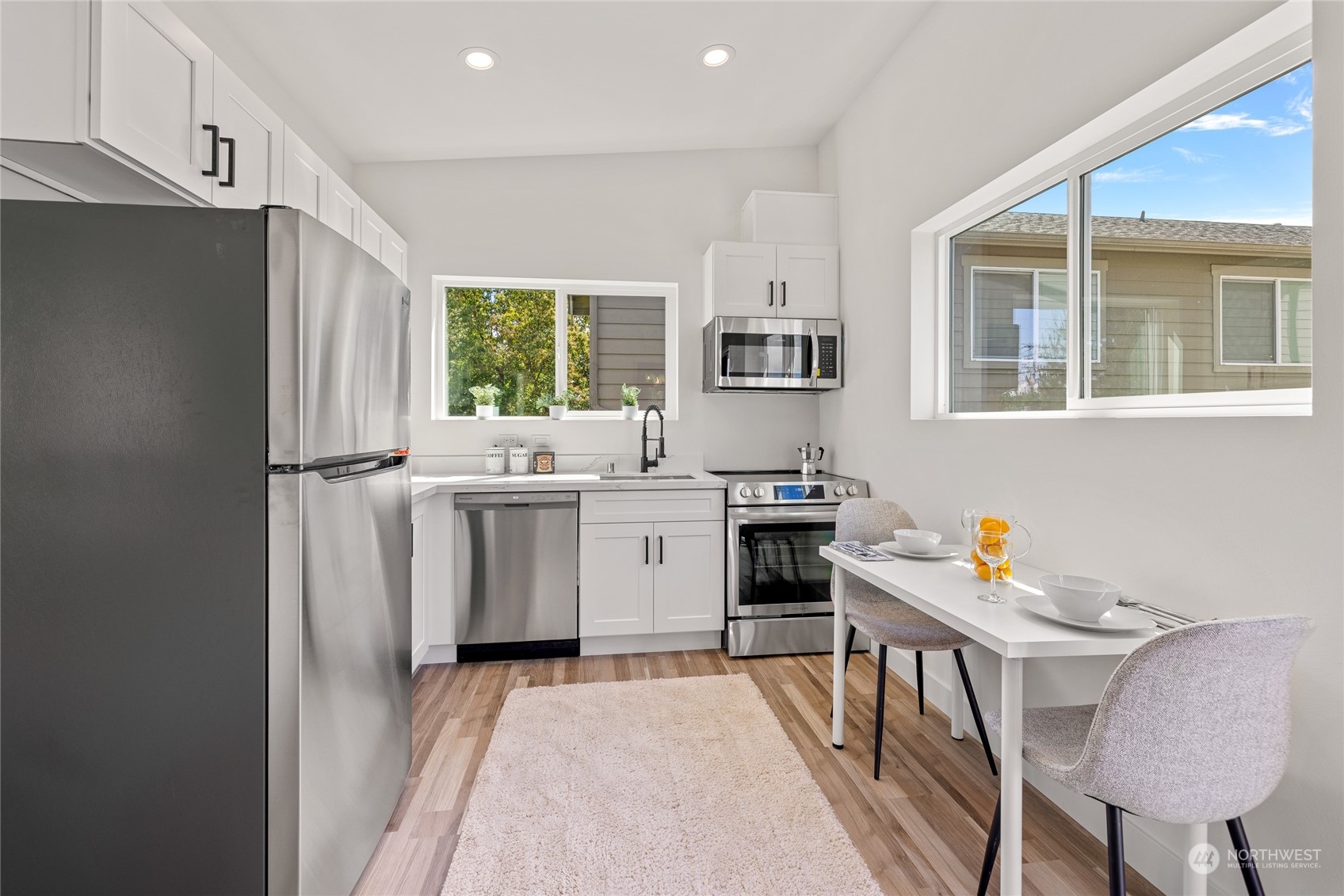 1042 South Director Street Seattle, WA 98108 - Photo 30 of 40 a kitchen with a sink appliances cabinets and a window