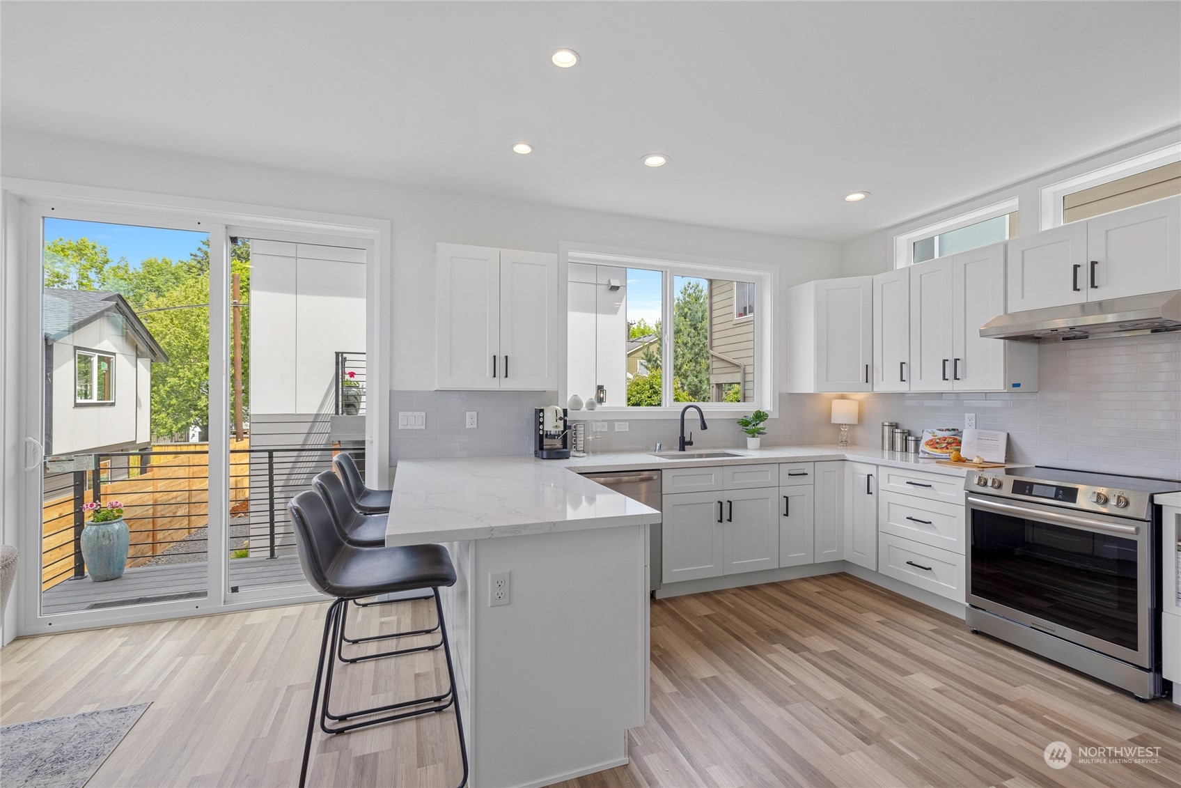 1042 South Director Street Seattle, WA 98108 - Photo 8 of 40 a kitchen with sink cabinets and wooden floor