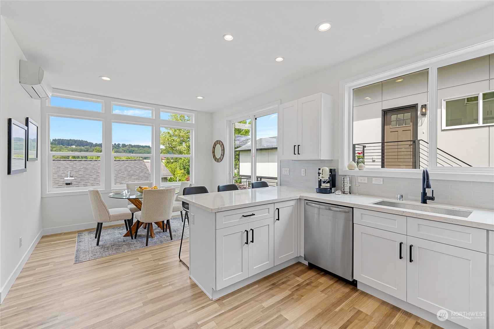 1042 South Director Street Seattle, WA 98108 - Photo 9 of 40 a kitchen with a sink wooden floor dining table and chairs