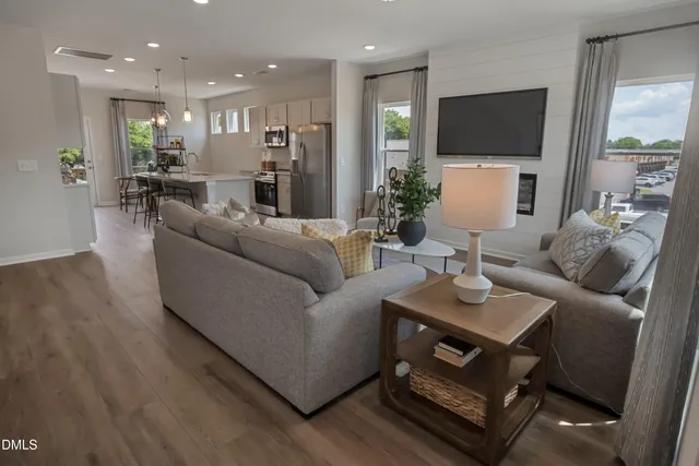 a dining room with furniture a kitchen view and chandelier