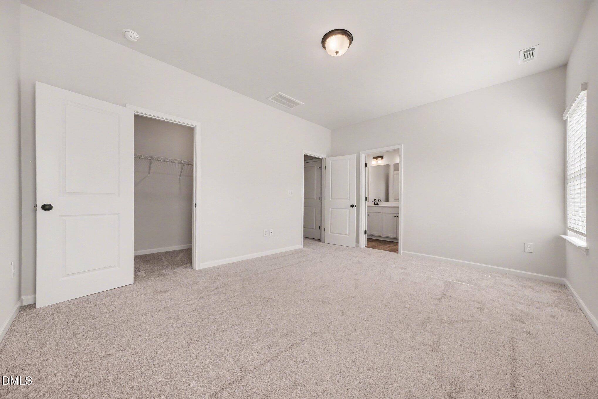 720 Orch Vista Circle Raleigh, NC 27606 - Photo 9 of 28 an empty room with an entryway and kitchen