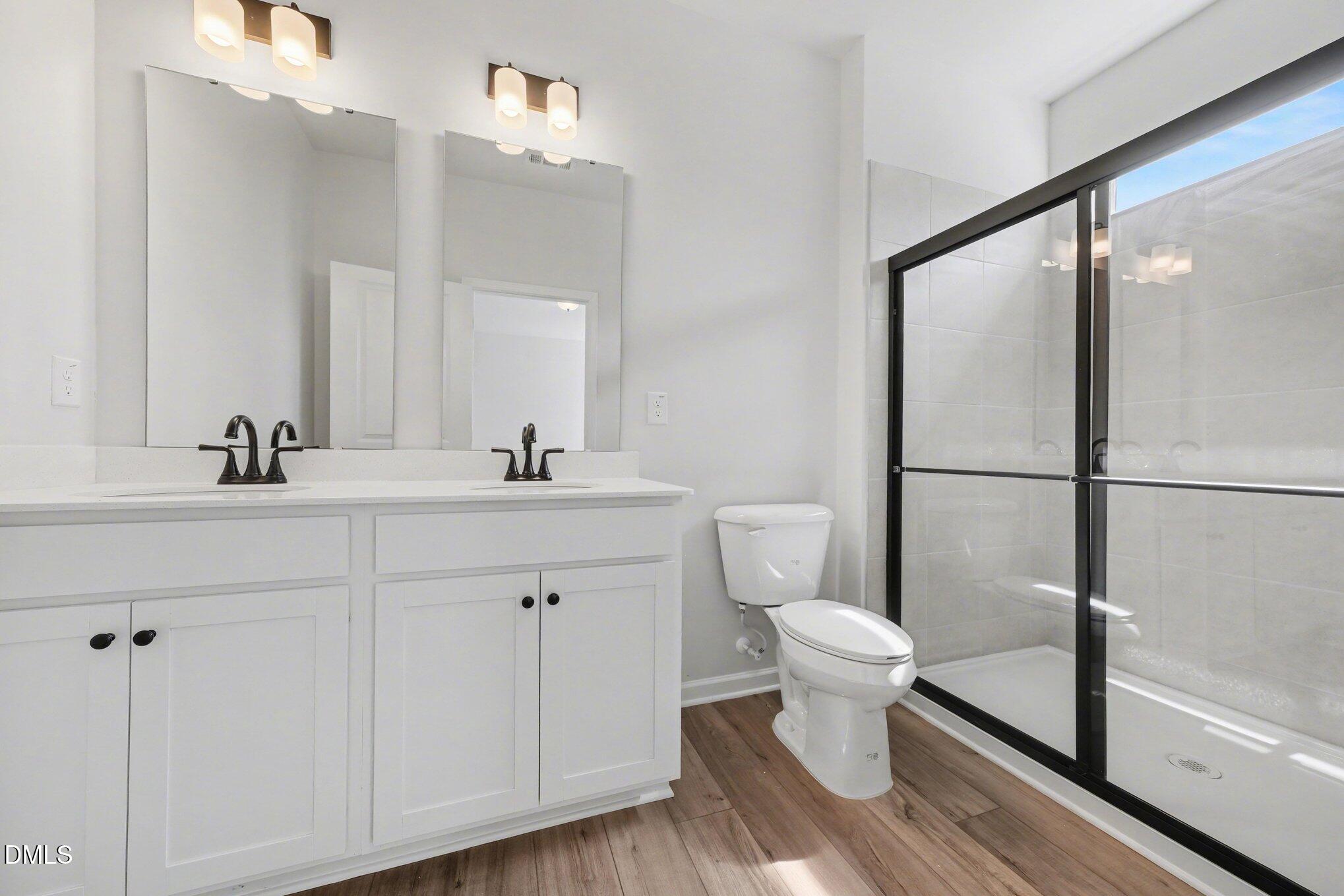 720 Orch Vista Circle Raleigh, NC 27606 - Photo 11 of 28 a bathroom with a toilet sink and a mirror