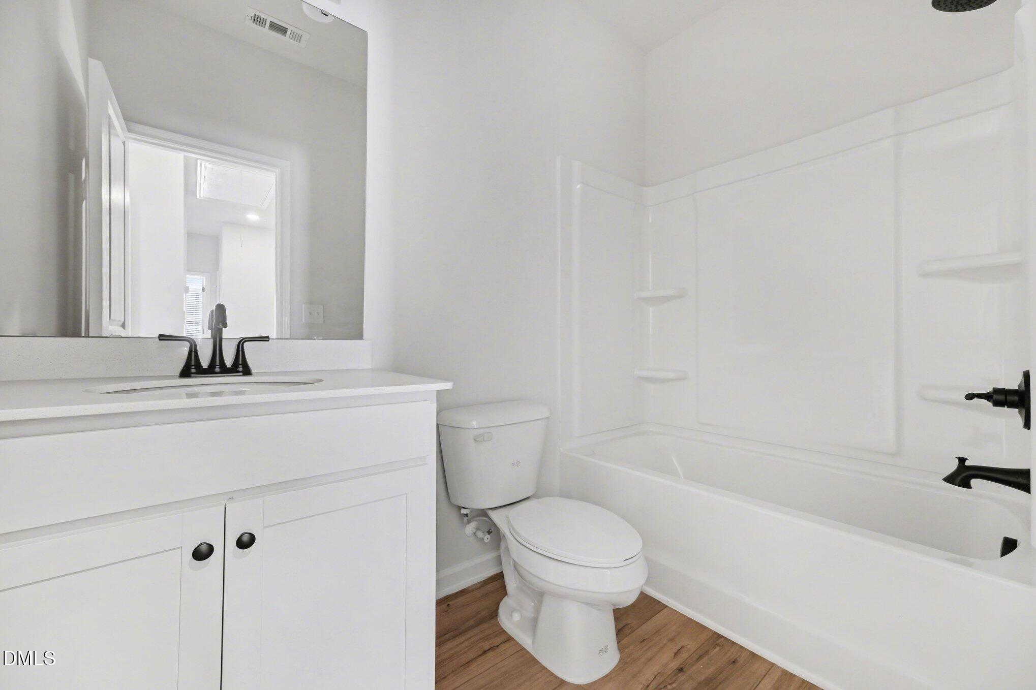 720 Orch Vista Circle Raleigh, NC 27606 - Photo 14 of 28 a bathroom with a sink a toilet and bathtub