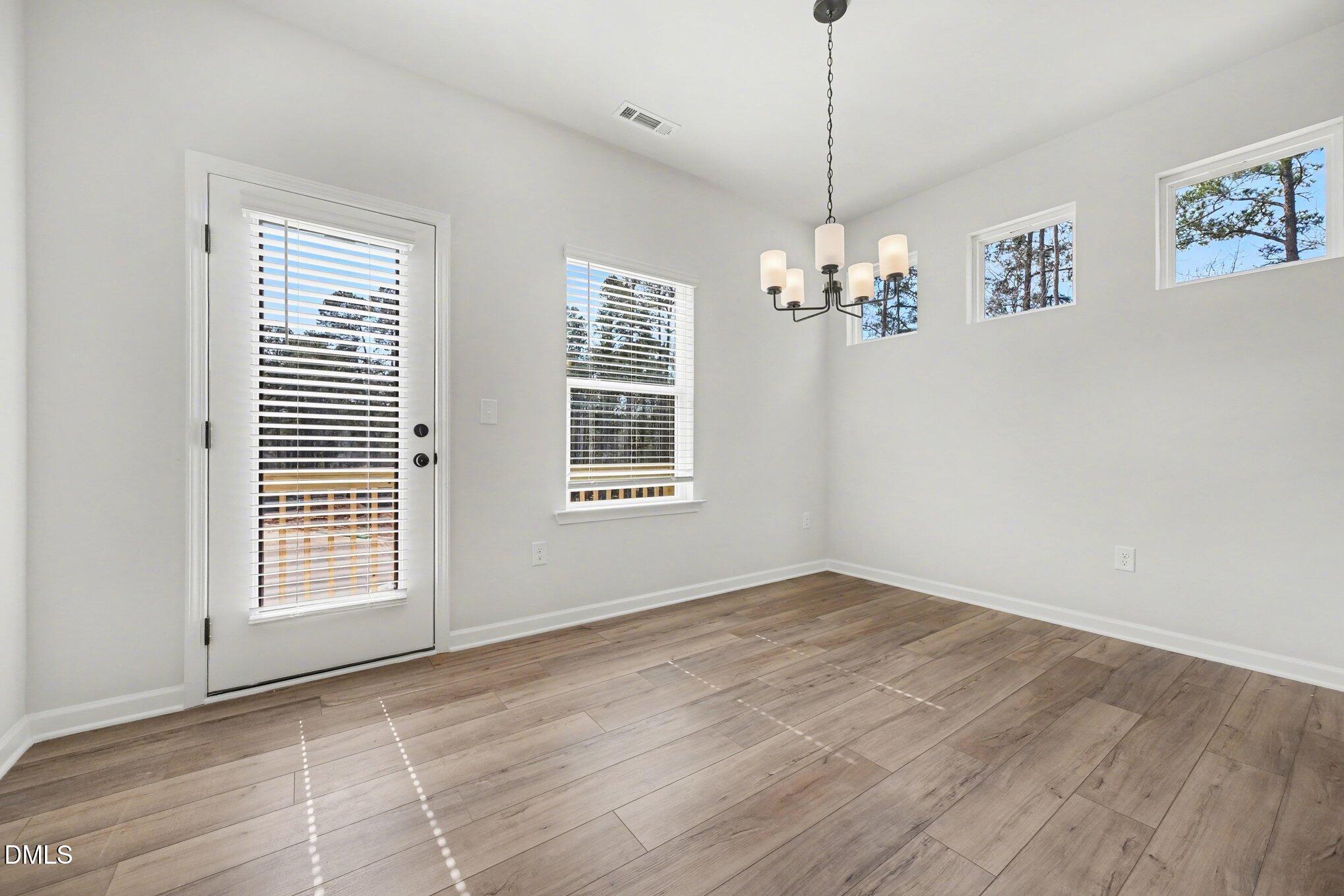 720 Orch Vista Circle Raleigh, NC 27606 - Photo 4 of 28 a view of a room with window and chandelier