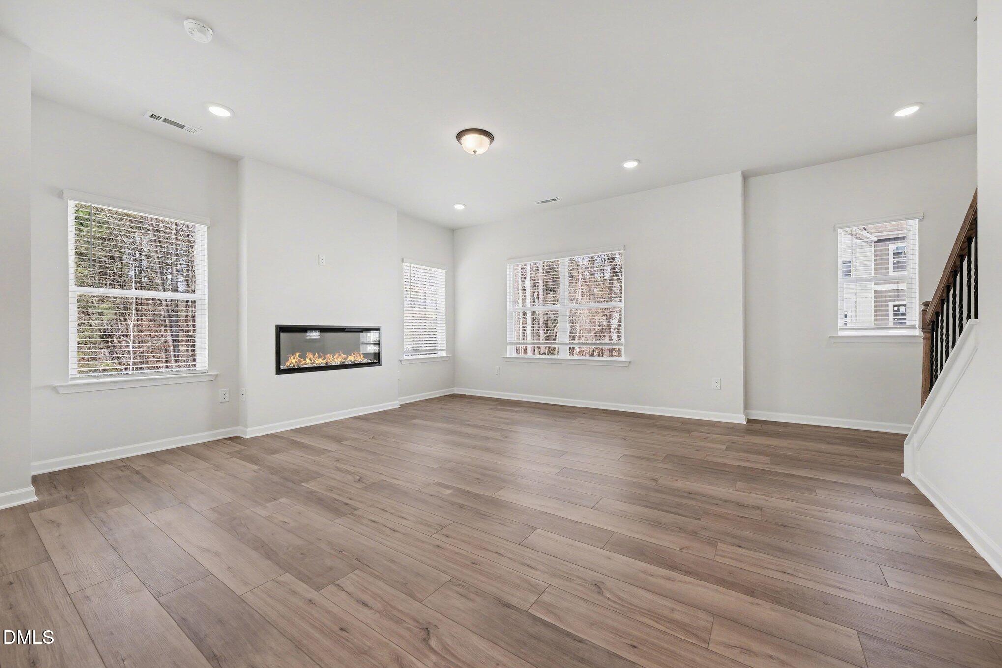 720 Orch Vista Circle Raleigh, NC 27606 - Photo 5 of 28 a view of empty room with wooden floor and windows