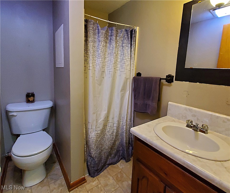 13075 Conquer Hill Road Byesville, OH 43723 - Photo 16 of 36 Bathroom featuring vanity and curtained shower