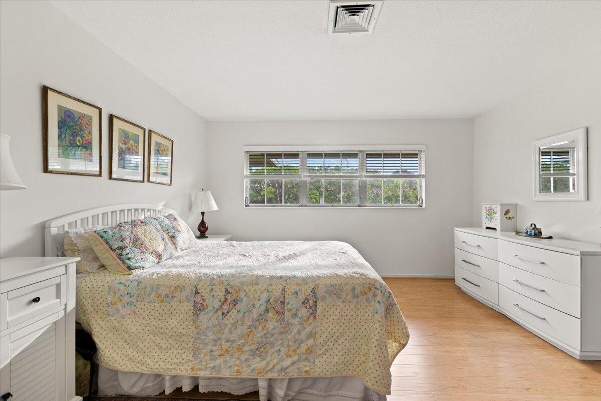 233 Rio Vista Circle, Unit 233 Atlantis, FL 33462 - Photo 15 of 33 a bed sitting in a bedroom next to a window