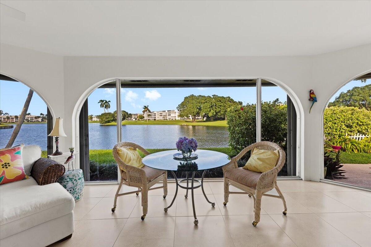 233 Rio Vista Circle, Unit 233 Atlantis, FL 33462 - Photo 2 of 33 a dining room with furniture and a floor to ceiling window