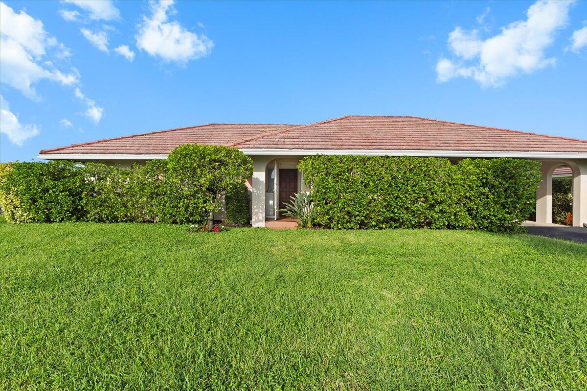 233 Rio Vista Circle, Unit 233 Atlantis, FL 33462 - Photo 27 of 33 a view of a house with a garden