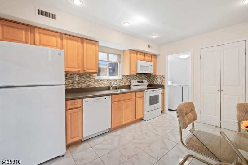 488 Auten Road, Unit 2D Hillsborough, NJ 08844 - Photo 11 of 30 a kitchen with stainless steel appliances granite countertop a refrigerator sink and white cabinets