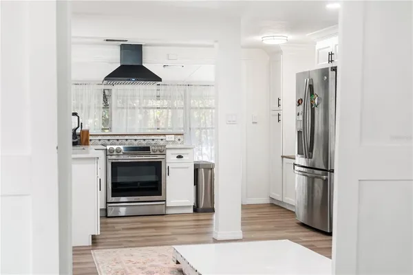 a kitchen with stainless steel appliances a stove and a refrigerator
