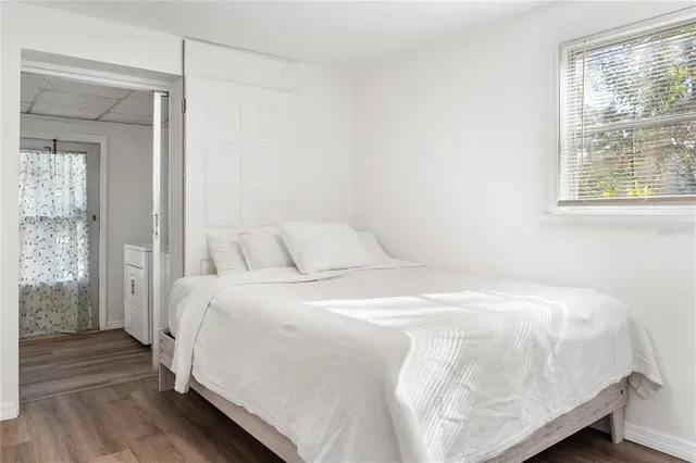 a large bed sitting in a bedroom next to a window