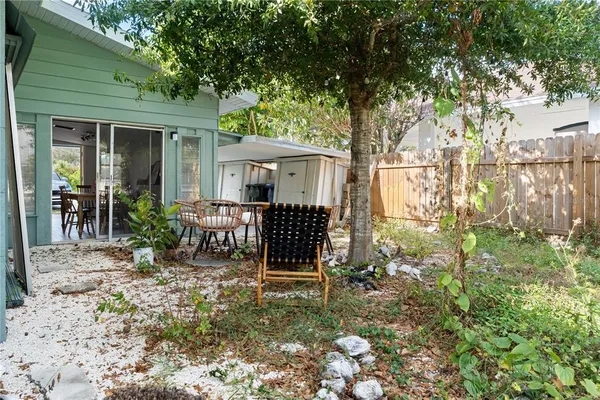 a view of a house with backyard and sitting area
