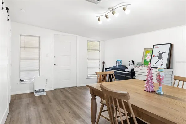 a view of a dining room with furniture and wooden floor