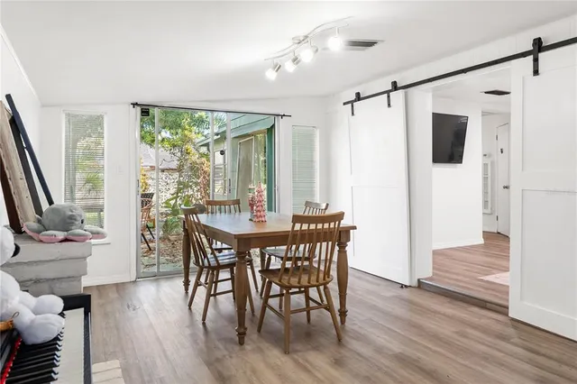 a view of a dining room with furniture window and wooden floor
