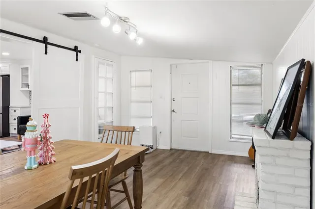 a view of a dining room with furniture and a chandelier
