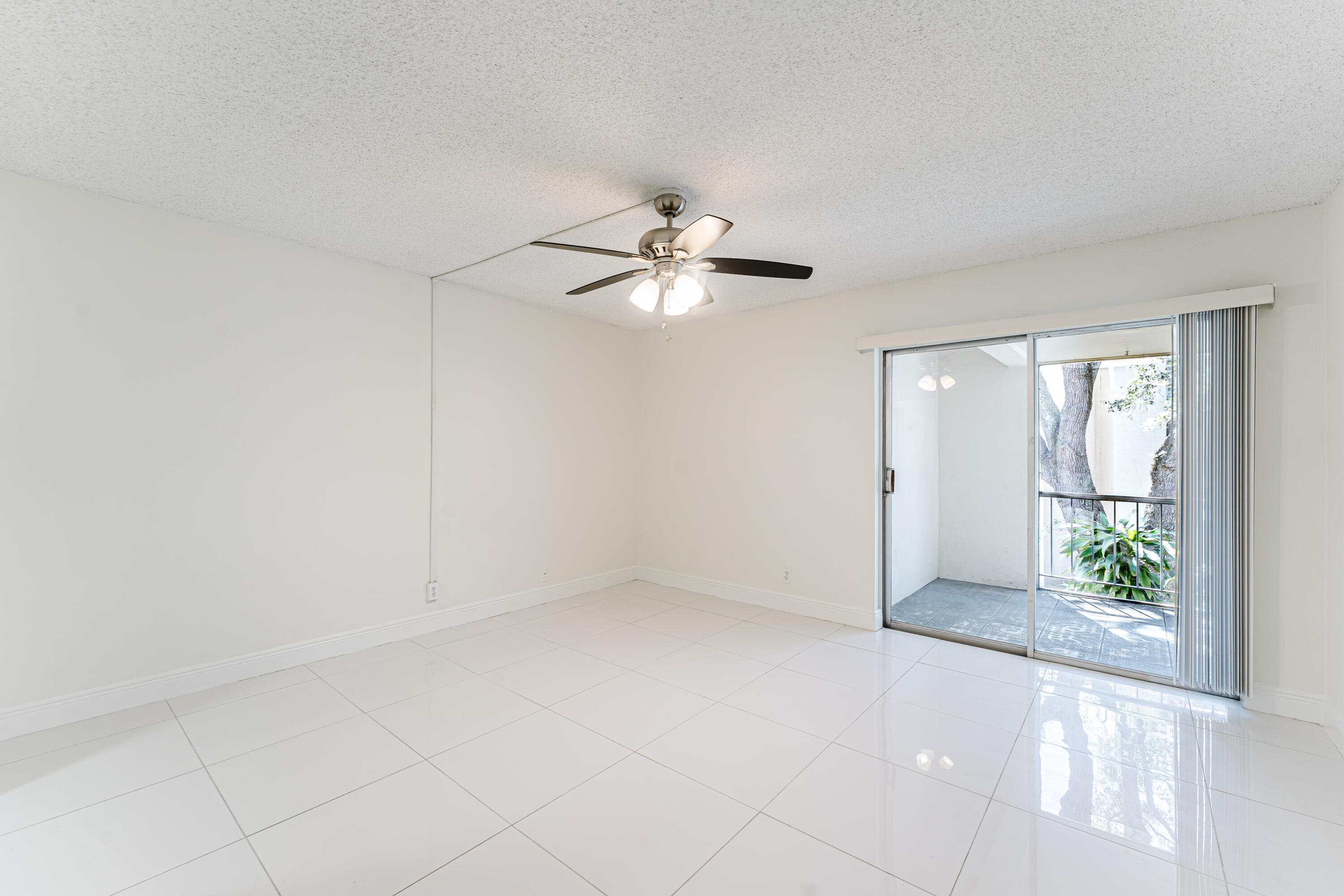 606 Northwest 13th Street, Unit 23 Boca Raton, FL 33486 - Photo 22 of 37 wooden floor in an empty room with a window