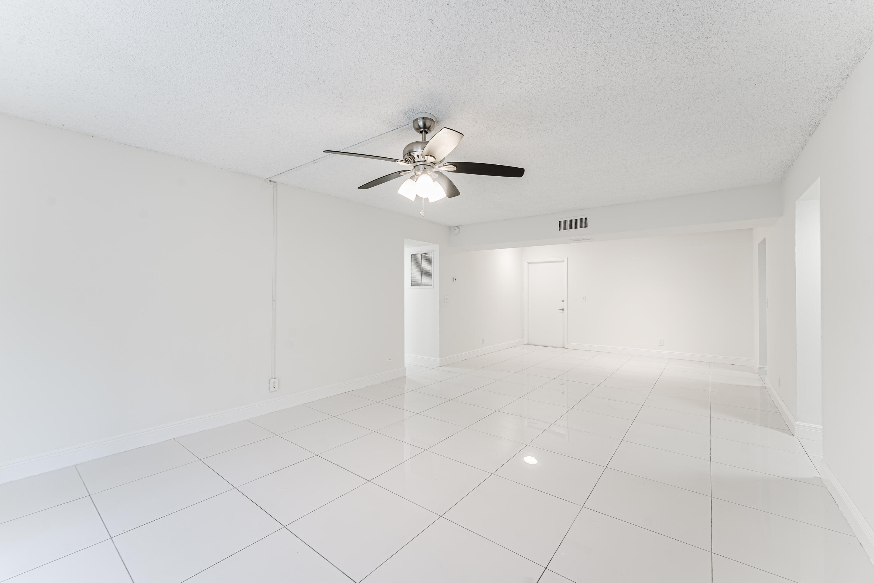 606 Northwest 13th Street, Unit 23 Boca Raton, FL 33486 - Photo 9 of 37 a view of an empty room with a ceiling fan