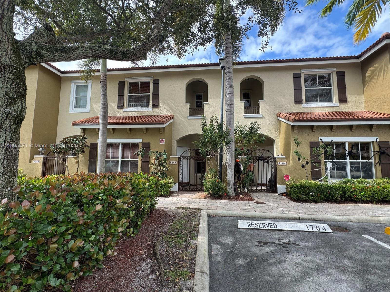3166 Merrick Terrace, Unit 1705 Margate, FL 33063 - Photo 2 of 41 front view of a house with a yard