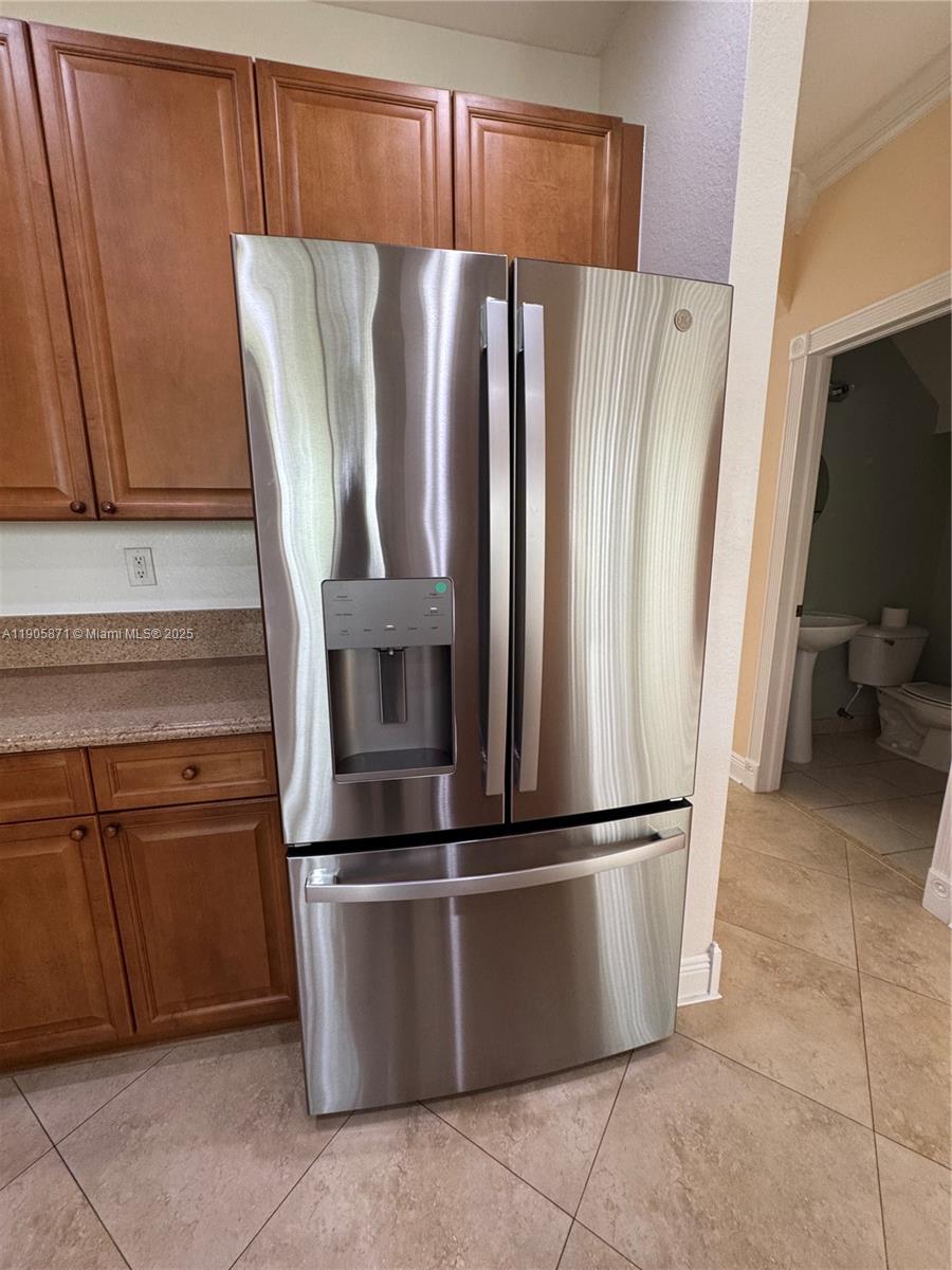 3166 Merrick Terrace, Unit 1705 Margate, FL 33063 - Photo 21 of 41 a metallic refrigerator freezer sitting in a kitchen