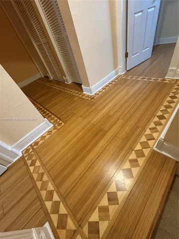 a view of a room with wooden floor and windows