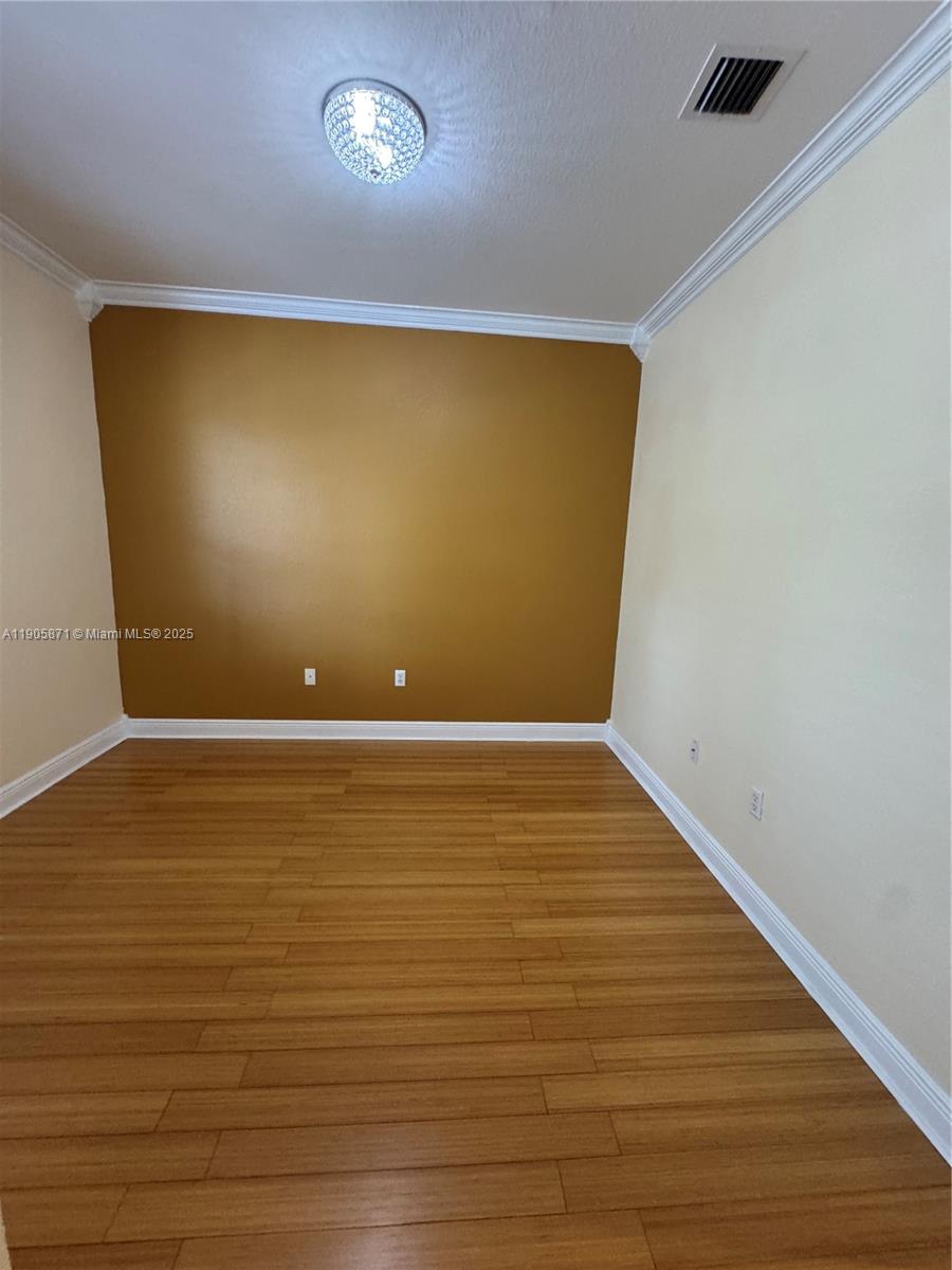 3166 Merrick Terrace, Unit 1705 Margate, FL 33063 - Photo 36 of 41 a view of an empty room with wooden floor