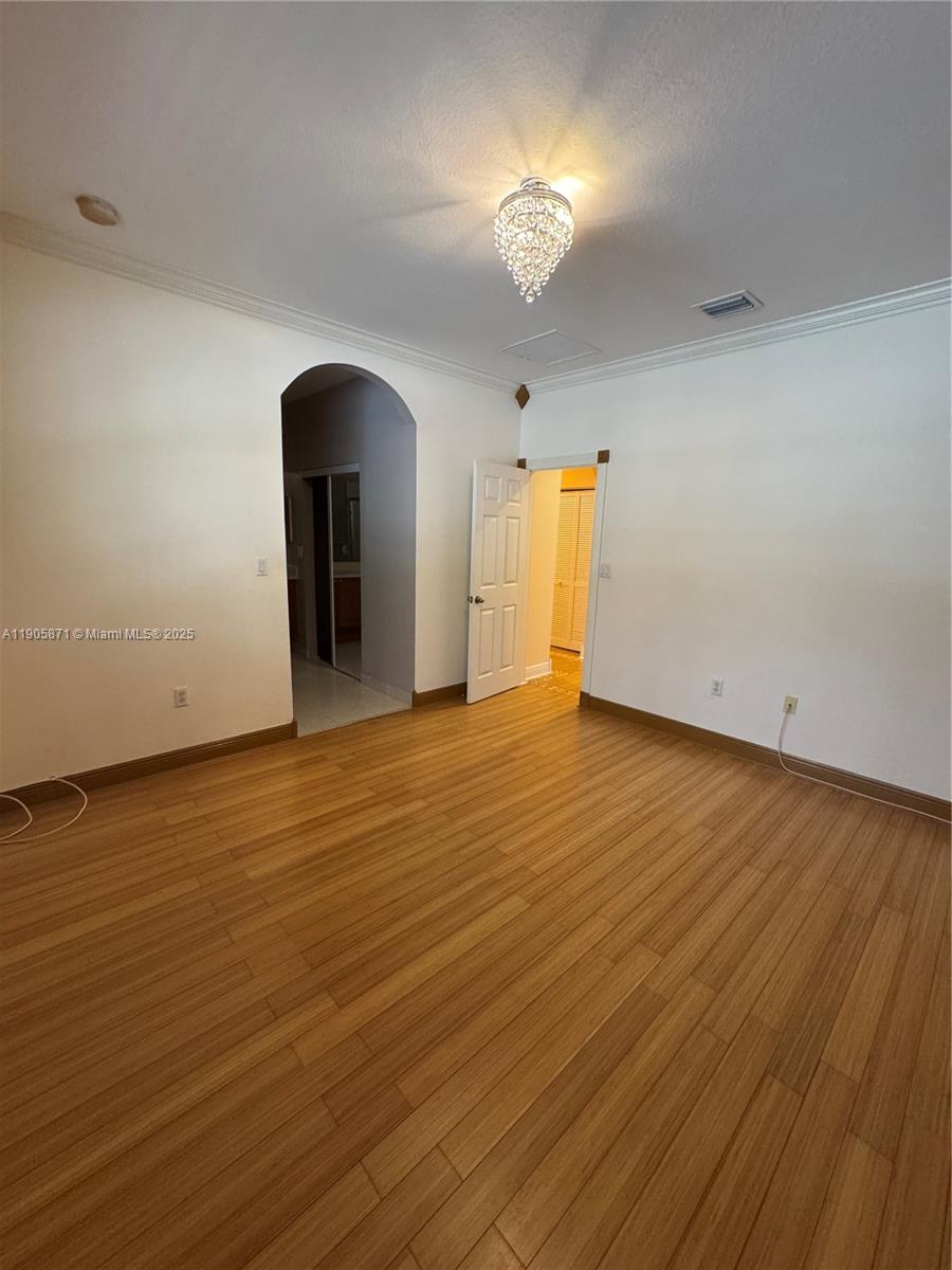 3166 Merrick Terrace, Unit 1705 Margate, FL 33063 - Photo 38 of 41 a view of an empty room with wooden floor and a window