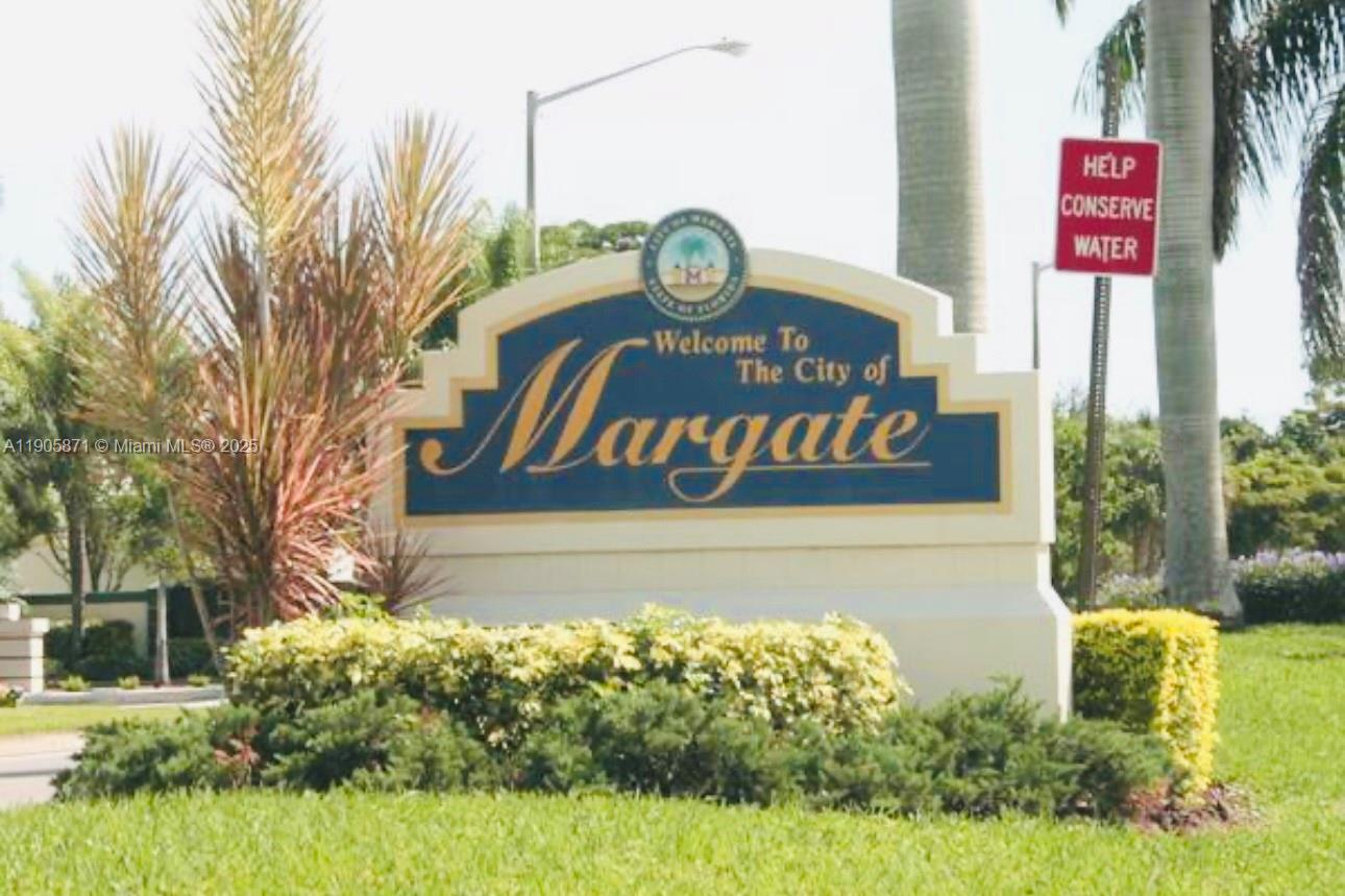 3166 Merrick Terrace, Unit 1705 Margate, FL 33063 - Photo 41 of 41 a sign that is on a brick wall