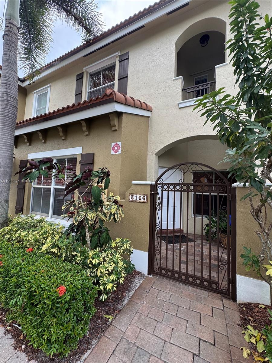 3166 Merrick Terrace, Unit 1705 Margate, FL 33063 - Photo 6 of 41 a front view of a house with garden