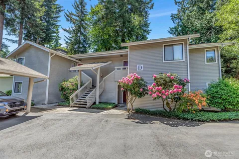 a view of a house with a yard and a garage