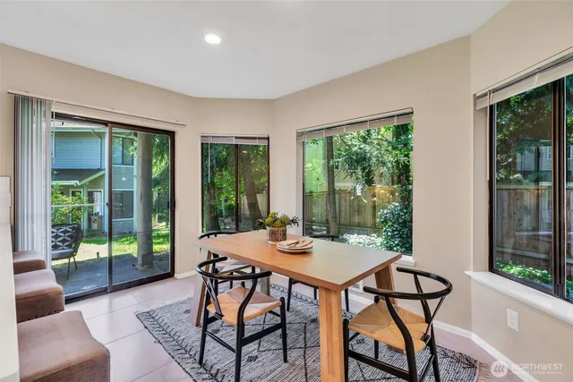 a view of a dining room with furniture large windows and wooden floor