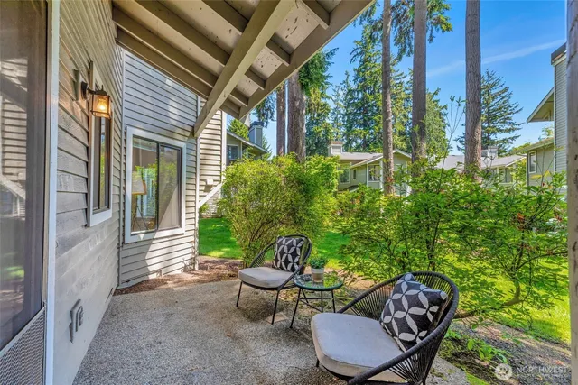 a view of a porch with furniture and a yard