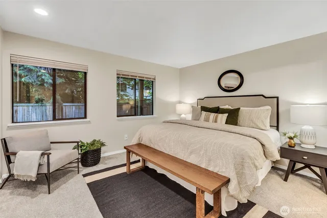 a bedroom with a bed and windows