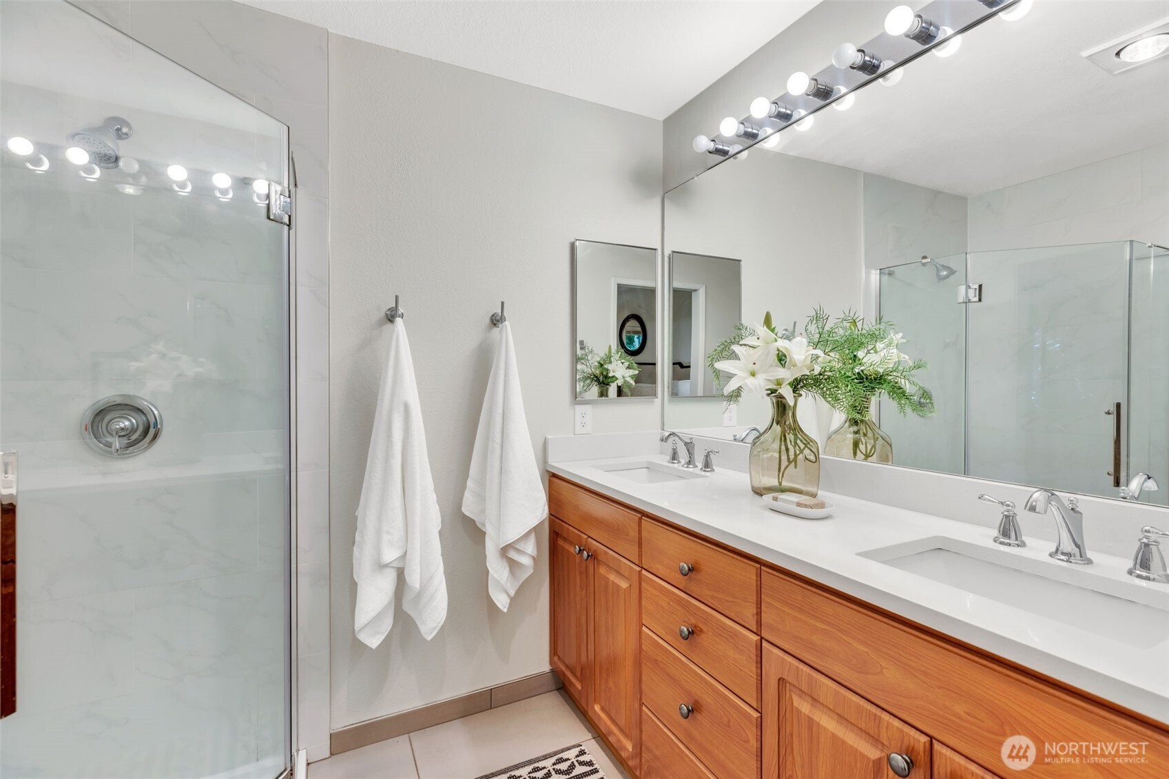9009 Avondale Road Northeast, Unit D107 Redmond, WA 98052 - Photo 19 of 34 a bathroom with a double vanity sink and a mirror