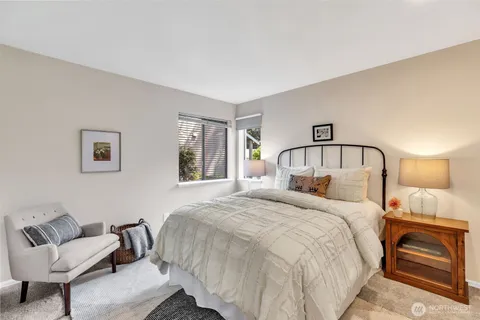 a bedroom with a bed and a mirror