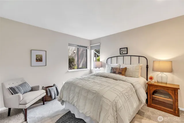 a bedroom with a bed and a mirror